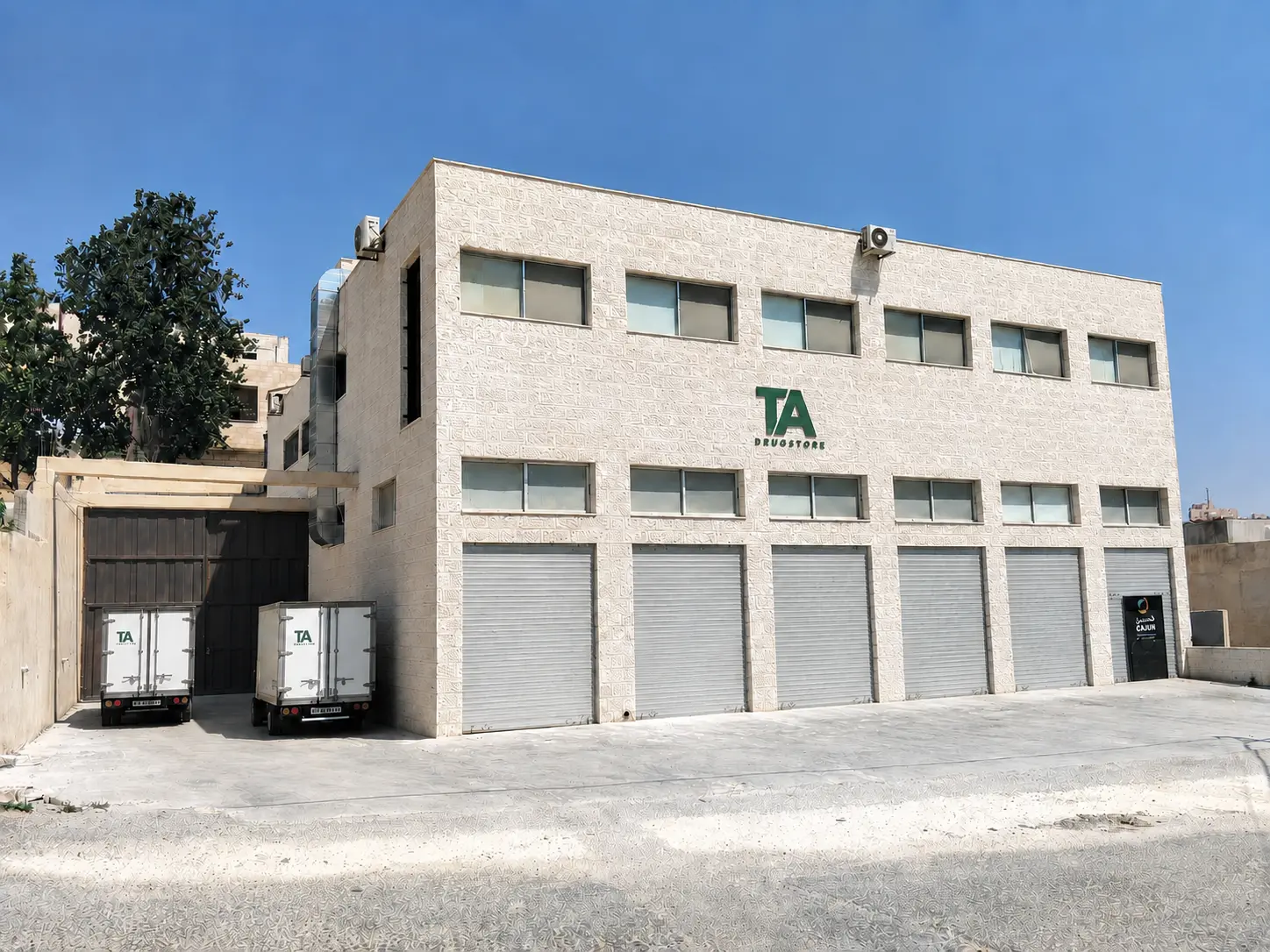 Real exterior view of the Taaluf Alkhair Drug Store headquarters in Amman